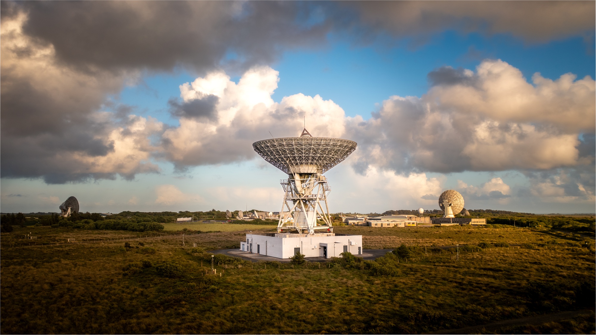 A large satellite dish pointing up into deep space