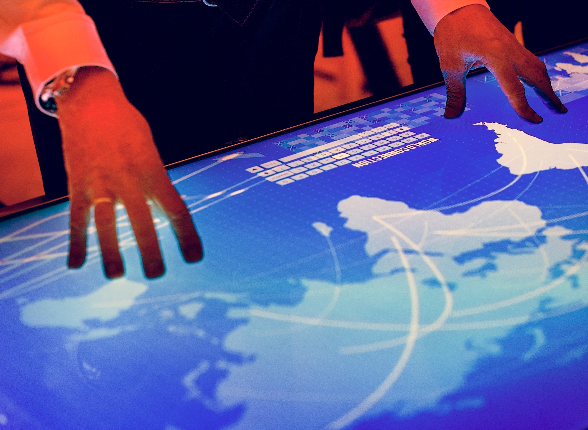 Hands touching a cyber space table screen