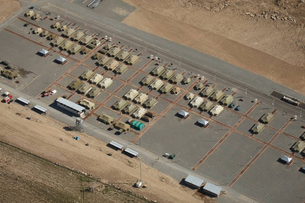 An overhead aerial shot of a military base in the desert.
