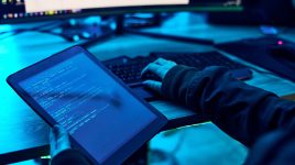 Tablet, html screen and programmer hands with coding software system for cyber security or hacking.